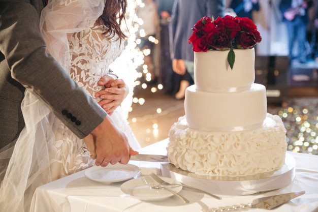 happy-bride-groom-cut-wedding-cake_8353-9297-1.jpg